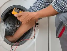 Washing machine repair technician testing a front-load washer with diagnostic tools in Anaheim, CA