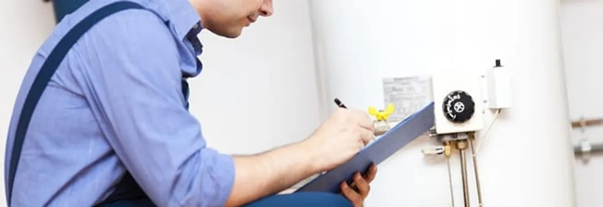Water heater repair technician inspecting the unit and recording service notes in Anaheim, CA